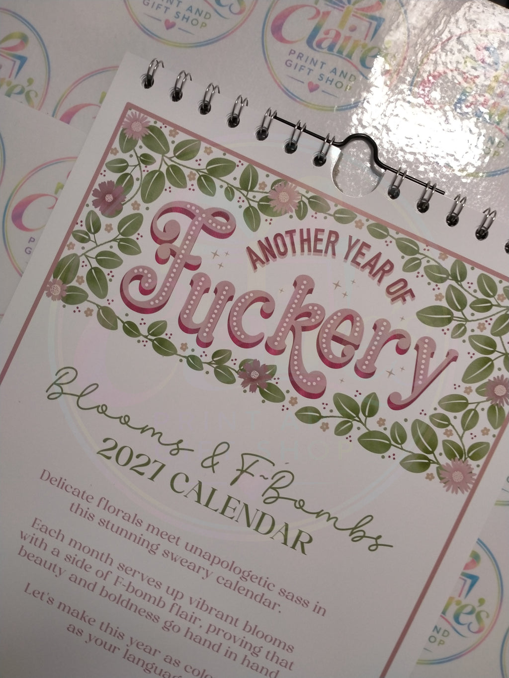 Angled close-up of the floral calendar front cover and wire binding