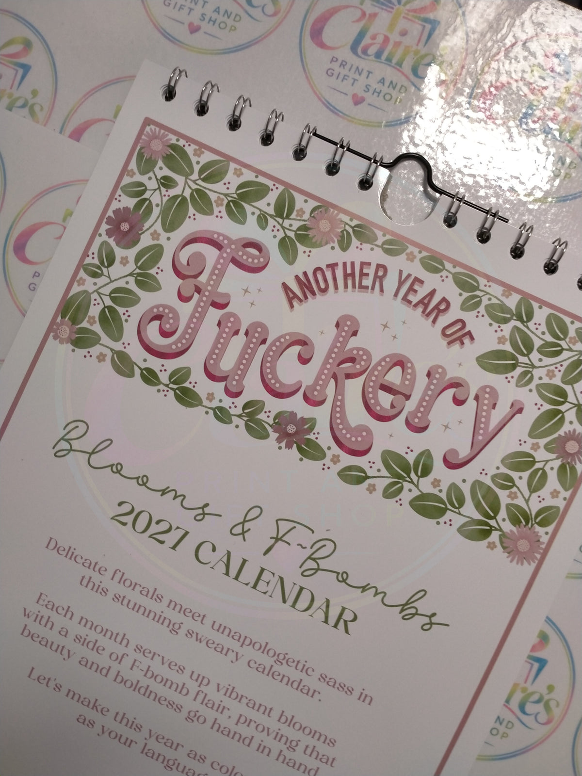 Angled close-up of the floral calendar front cover and wire binding