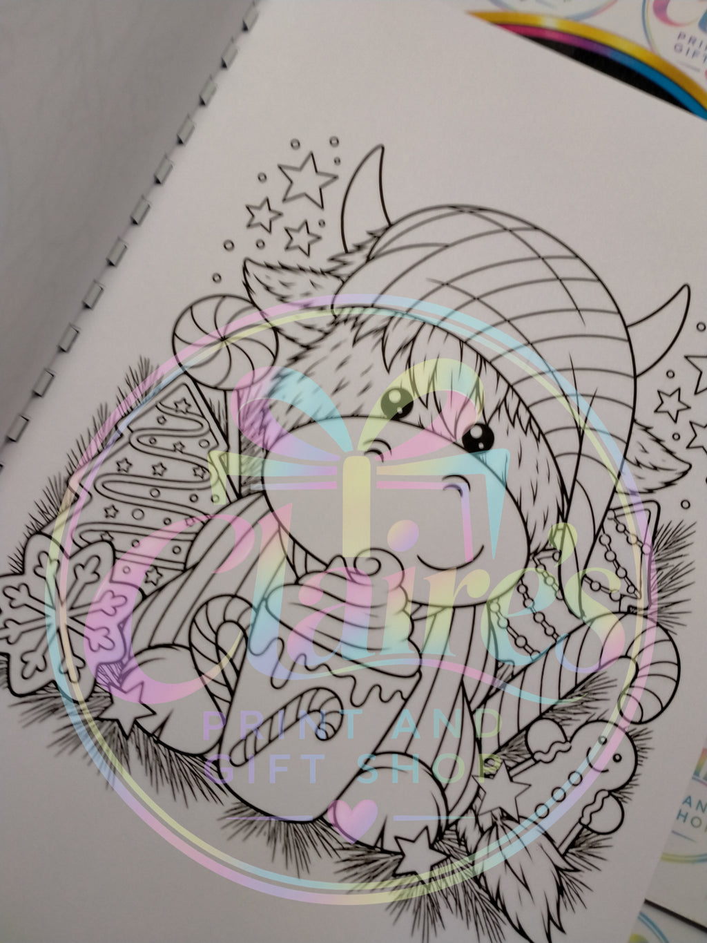 Highland cow with festive treats colouring page