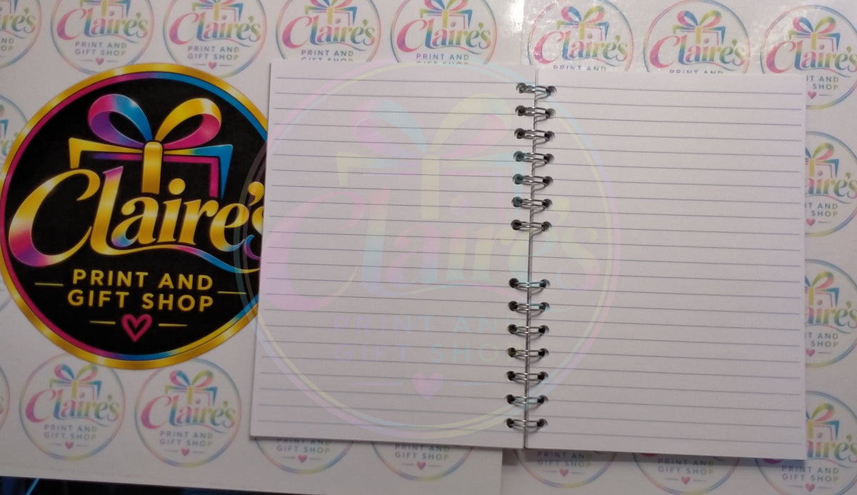 Open notebook showing lined pages and wire binding